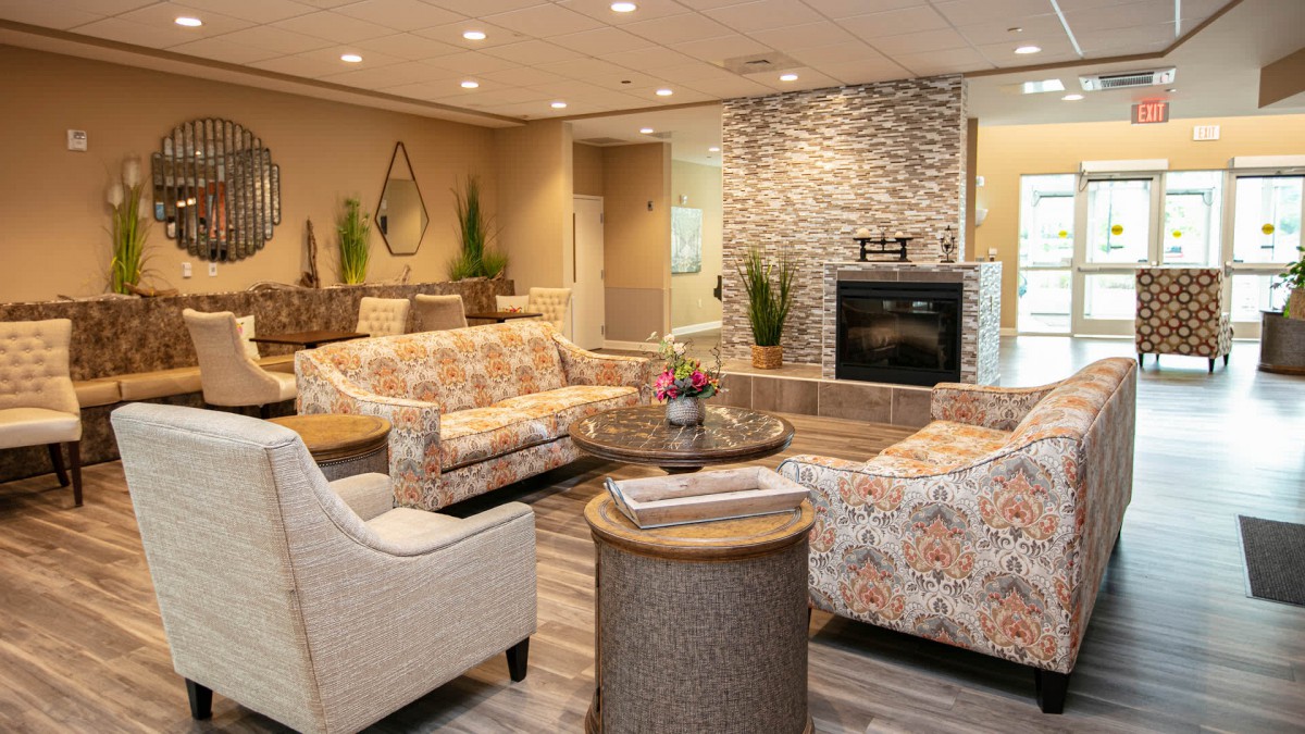 A cozy living room with comfortable seating and a modern fireplace.