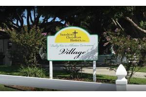 A sign for the Sunlight Christian Homes housing community.