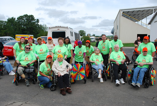 A vibrant community gathering, showcasing camaraderie and support among participants in matching green shirts.