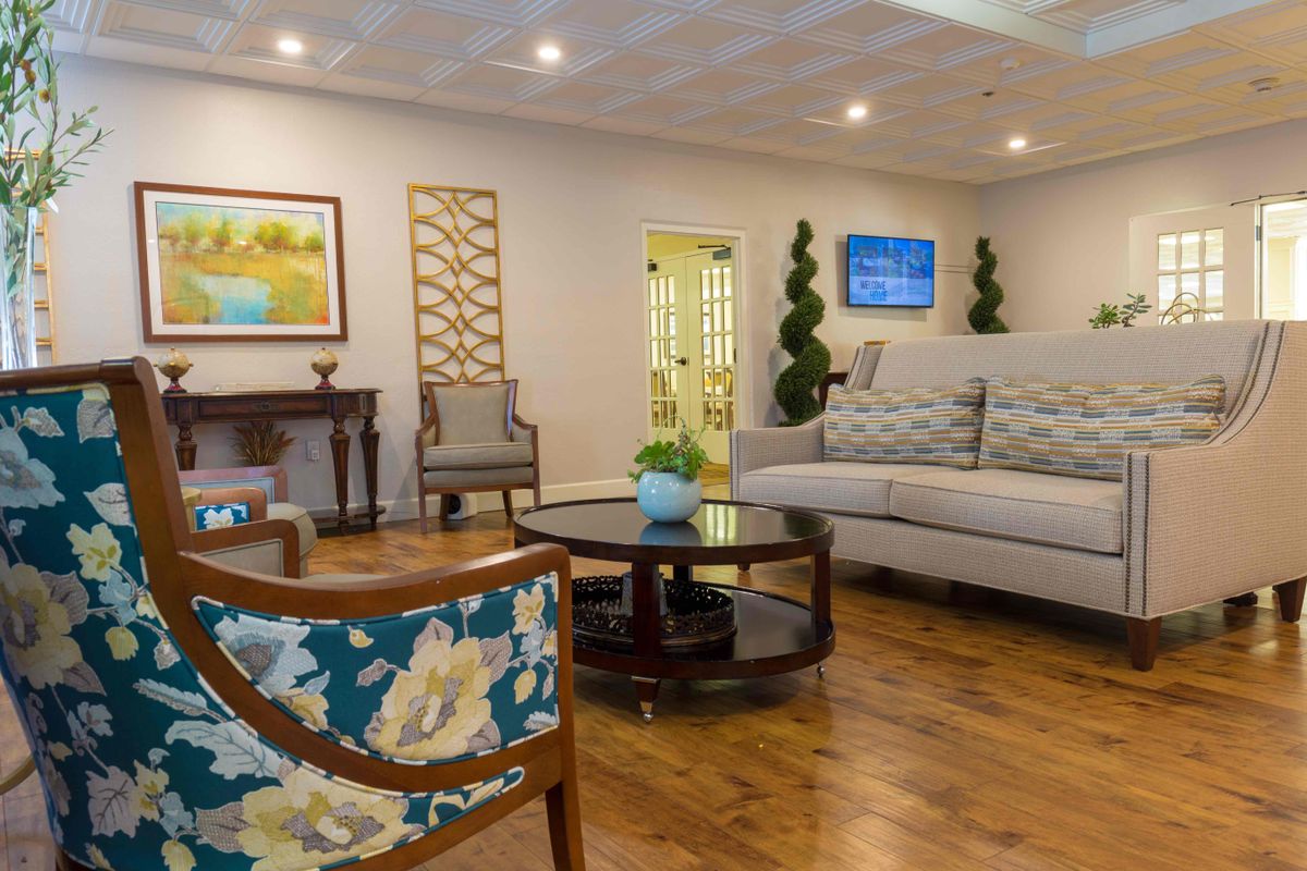 A cozy and elegantly decorated living room with a comfortable sofa, stylish furniture, and tasteful artwork.