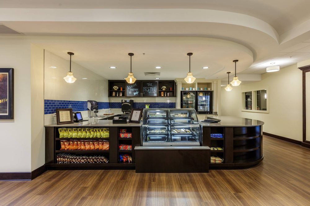 A modern cafe interior with a well-lit counter and display case.