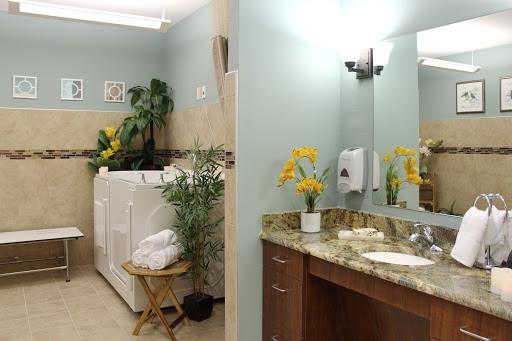 A stylish laundry and bathroom area featuring modern appliances and decorative plants.