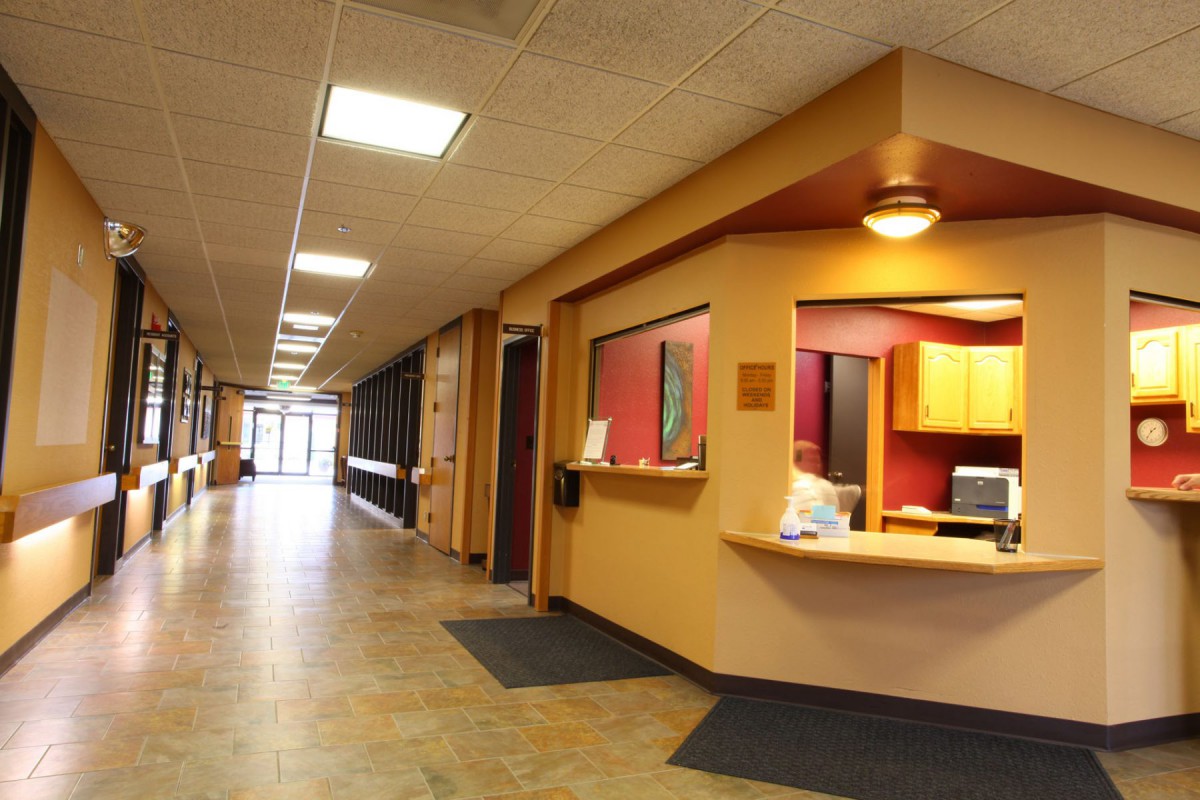 A modern office hallway with a reception desk.