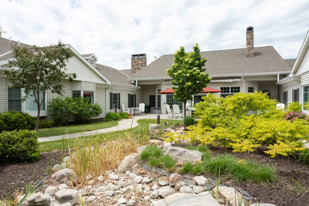 A beautiful house surrounded by a well-maintained garden and lush greenery.