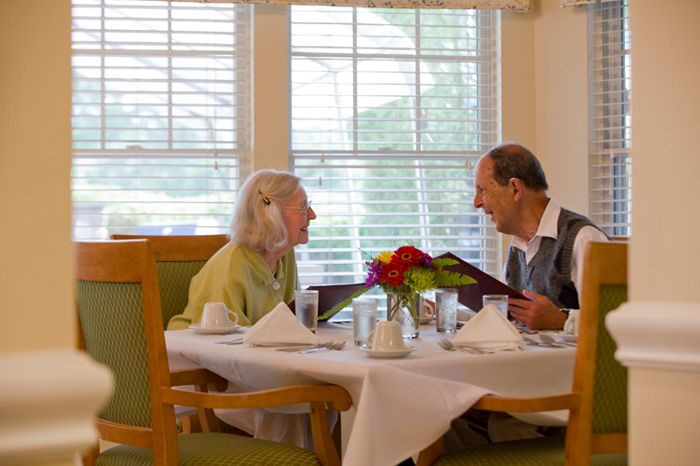 An elderly couple enjoying a meal together at a restaurant.