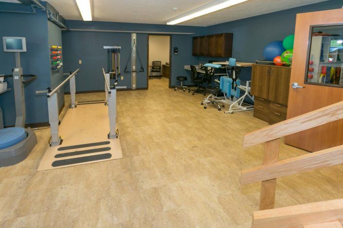A rehabilitation room equipped with exercise and therapy equipment.