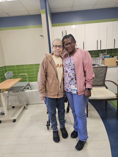 Two individuals posing together in a friendly environment, showcasing joy and camaraderie.