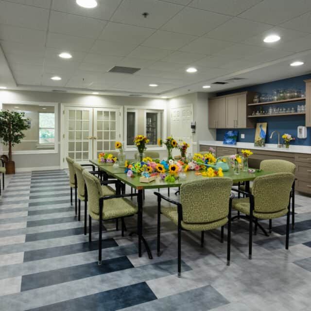 A modern dining room setup with a long table and chairs, ready for a meeting or gathering.