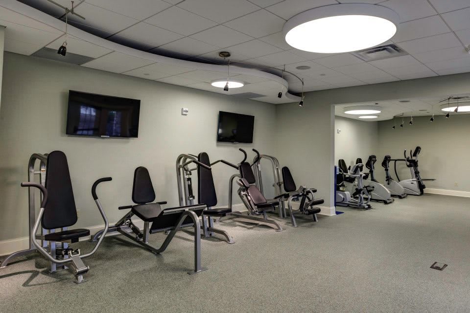 A modern gym with various exercise machines and equipment.