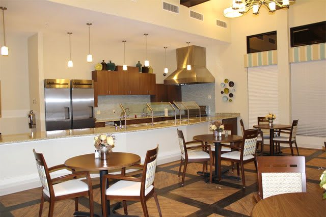 A modern kitchen and dining area with elegant seating and lighting.