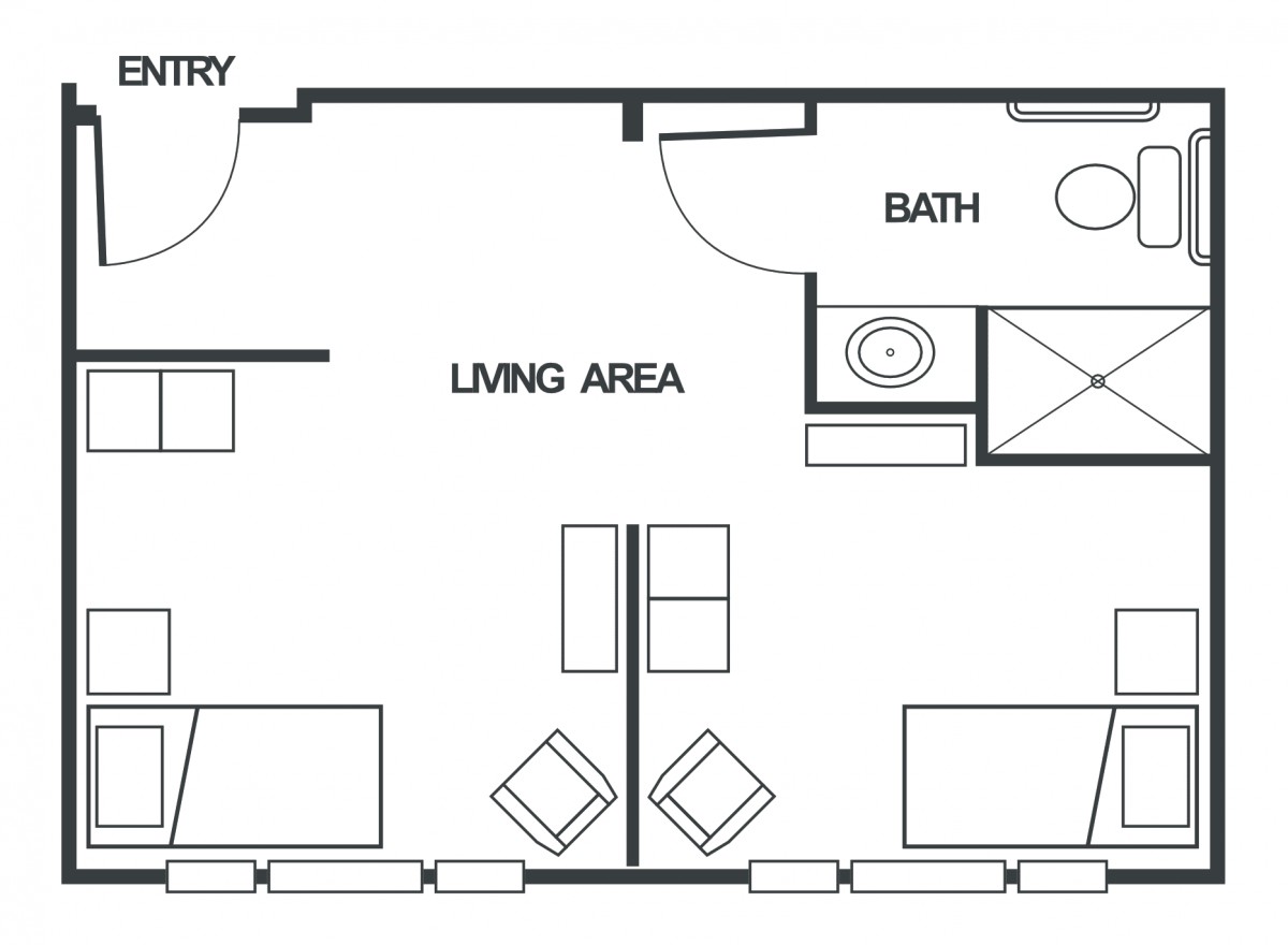 A floor plan depicting a living area with furniture and an adjacent bathroom.
