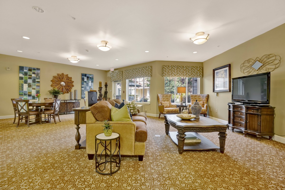 A spacious and elegantly decorated living room with stylish furniture and warm lighting.