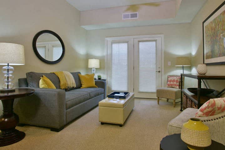 A cozy living room with a modern sofa, neutral tones, and decorative elements.