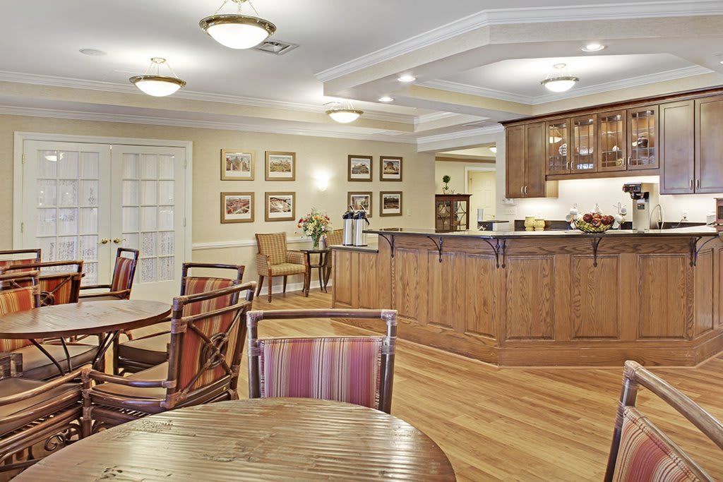 A well-lit lobby area with a wooden reception desk and comfortable seating.