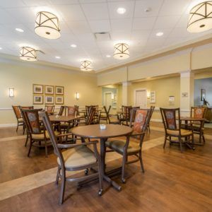 A spacious and well-lit dining area with multiple tables and chairs.