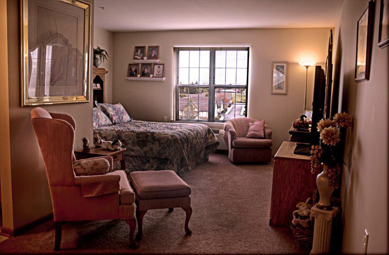 A cozy bedroom with elegant furniture and a window view.