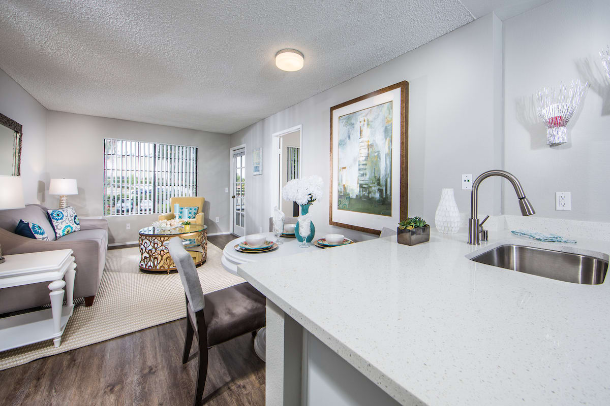 A modern open-plan apartment interior featuring a kitchen and living area with stylish decor.