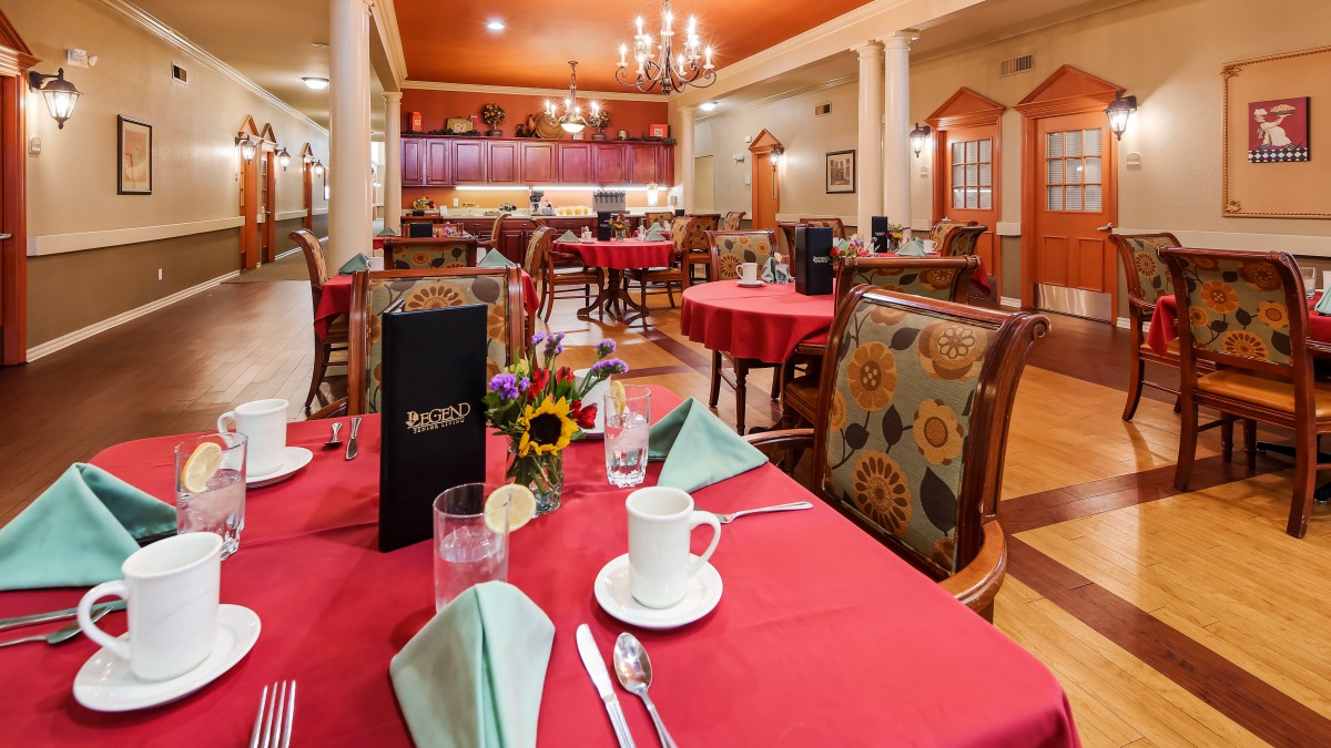A well-decorated restaurant dining area with neatly set tables and elegant furnishings.