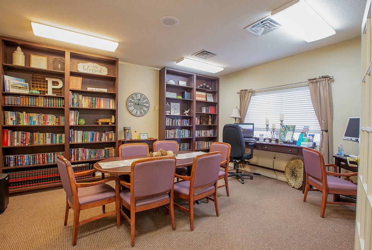 A well-organized office space with a meeting area and bookshelves.