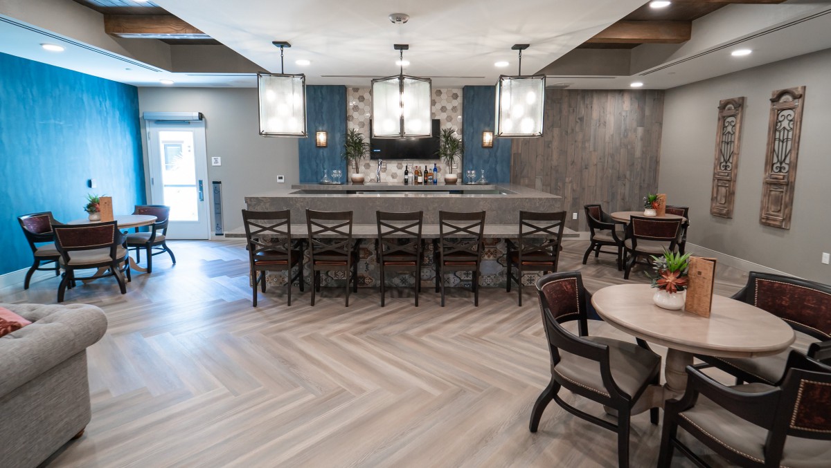 A modern bar area with stylish seating and elegant lighting.