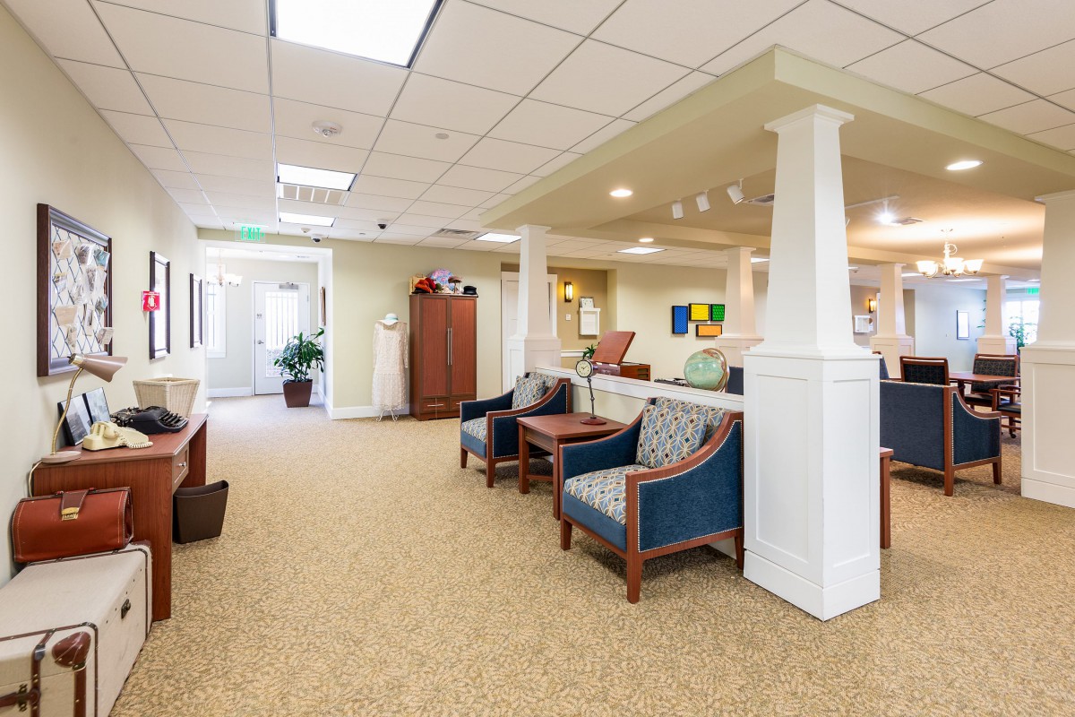 A well-lit waiting area with comfortable seating and a carpeted floor.