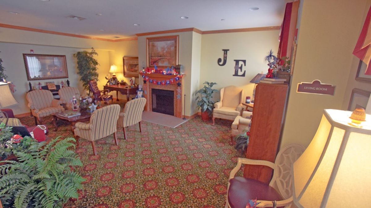 A cozy living room with a fireplace and comfortable seating area.
