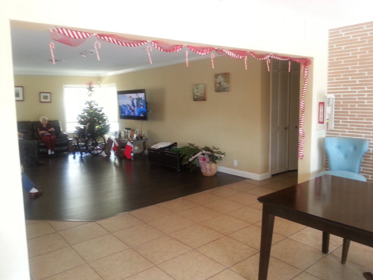 A cozy living room decorated for the holidays with a Christmas tree and presents.