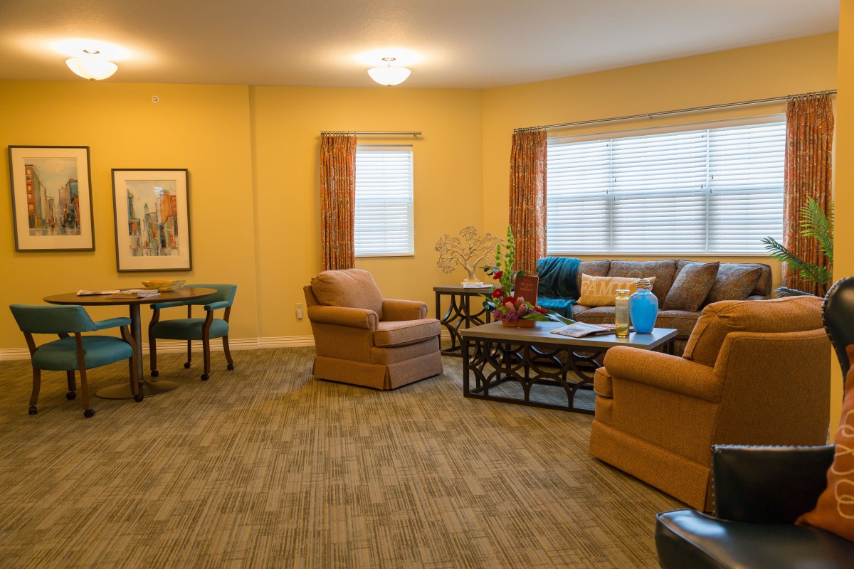 A cozy living room with comfortable seating and large windows.