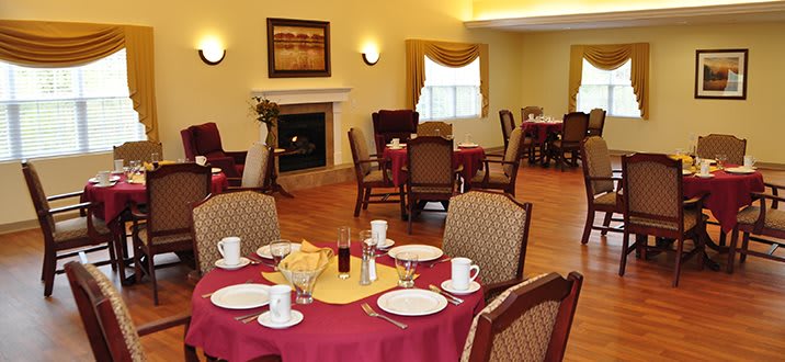 A cozy dining room with neatly set tables and a warm ambiance.