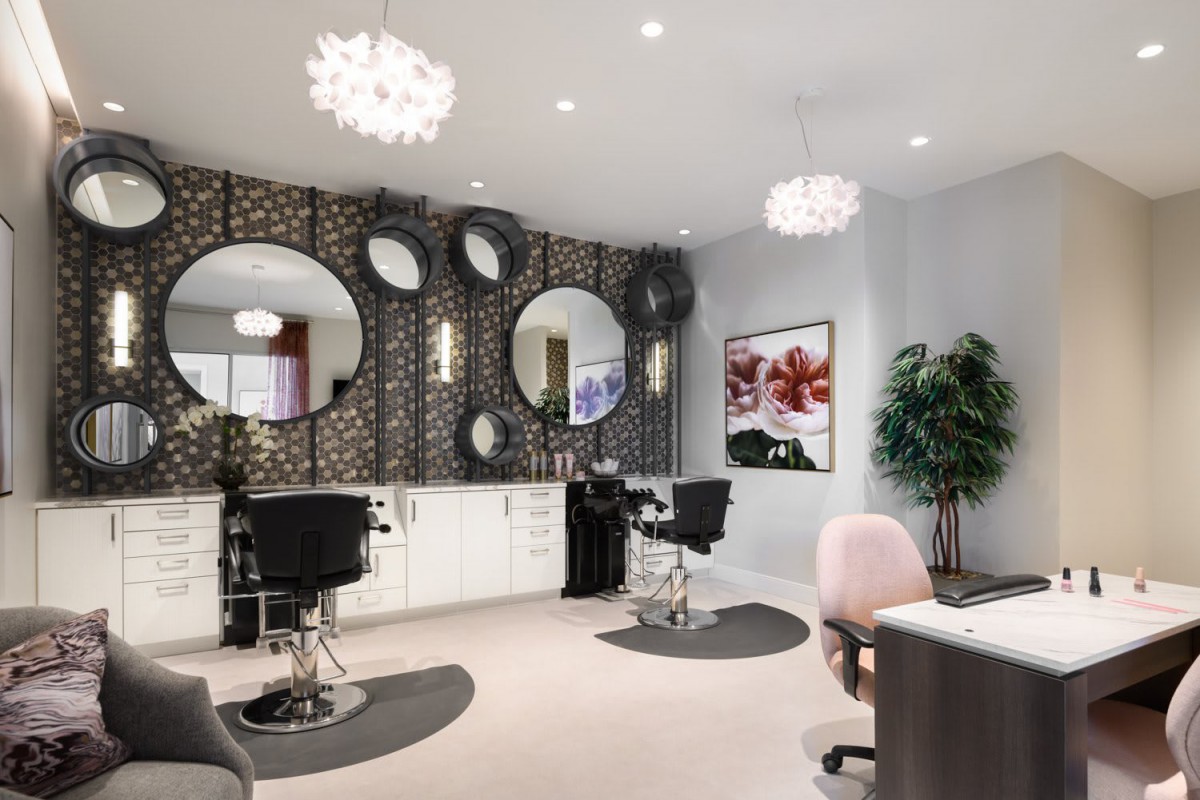 A stylish and modern salon interior with mirrors and comfortable seating.