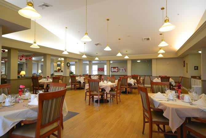 An elegant and spacious restaurant dining area with neatly arranged tables and chairs.