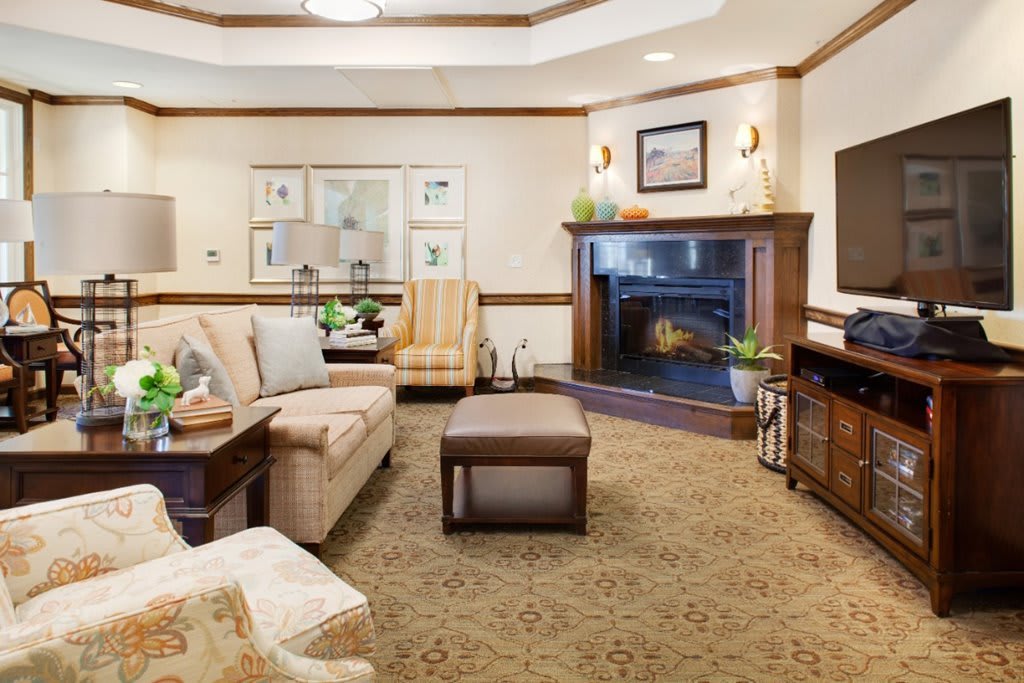 A cozy living room with a sofa, fireplace, and stylish decor.