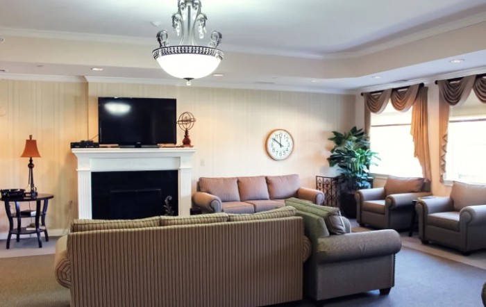A cozy living room with a fireplace, television, and comfortable seating.