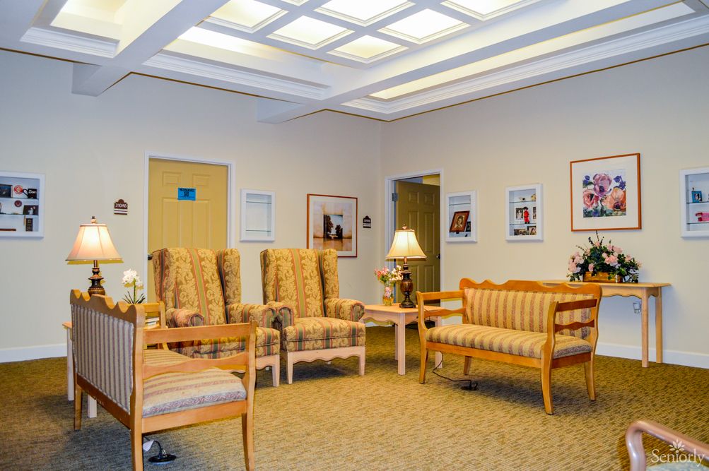 A comfortable waiting room with seating and artwork on the walls.