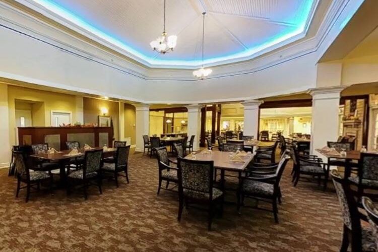 A spacious dining room with elegant seating and lighting.
