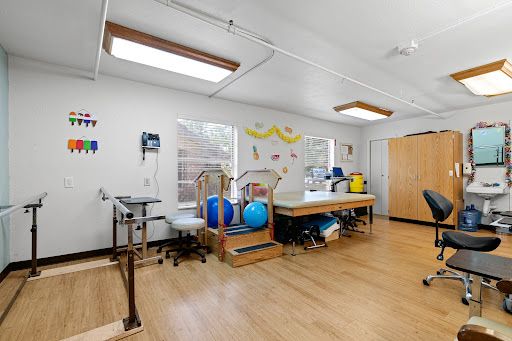 A bright and well-equipped therapy room designed for rehabilitation and physical therapy.