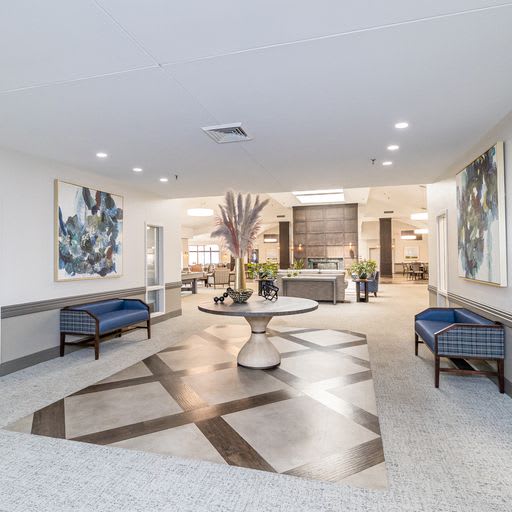 A modern and spacious lobby area with stylish furniture and artwork.