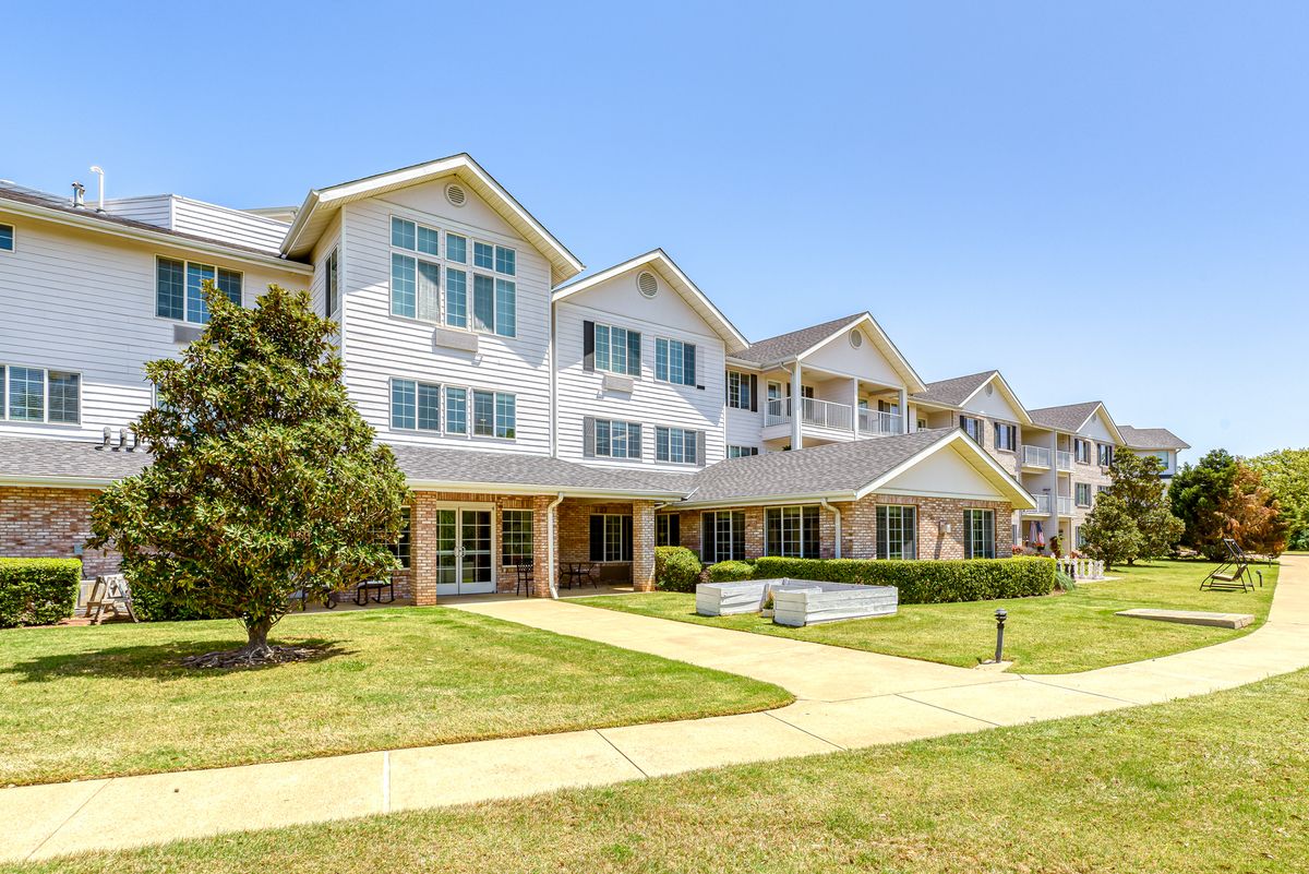 A modern residential apartment building with landscaped surroundings.