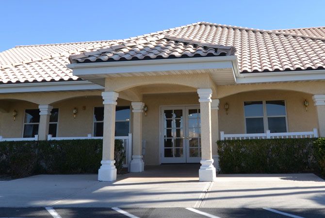 A building entrance with columns and a tiled roof.