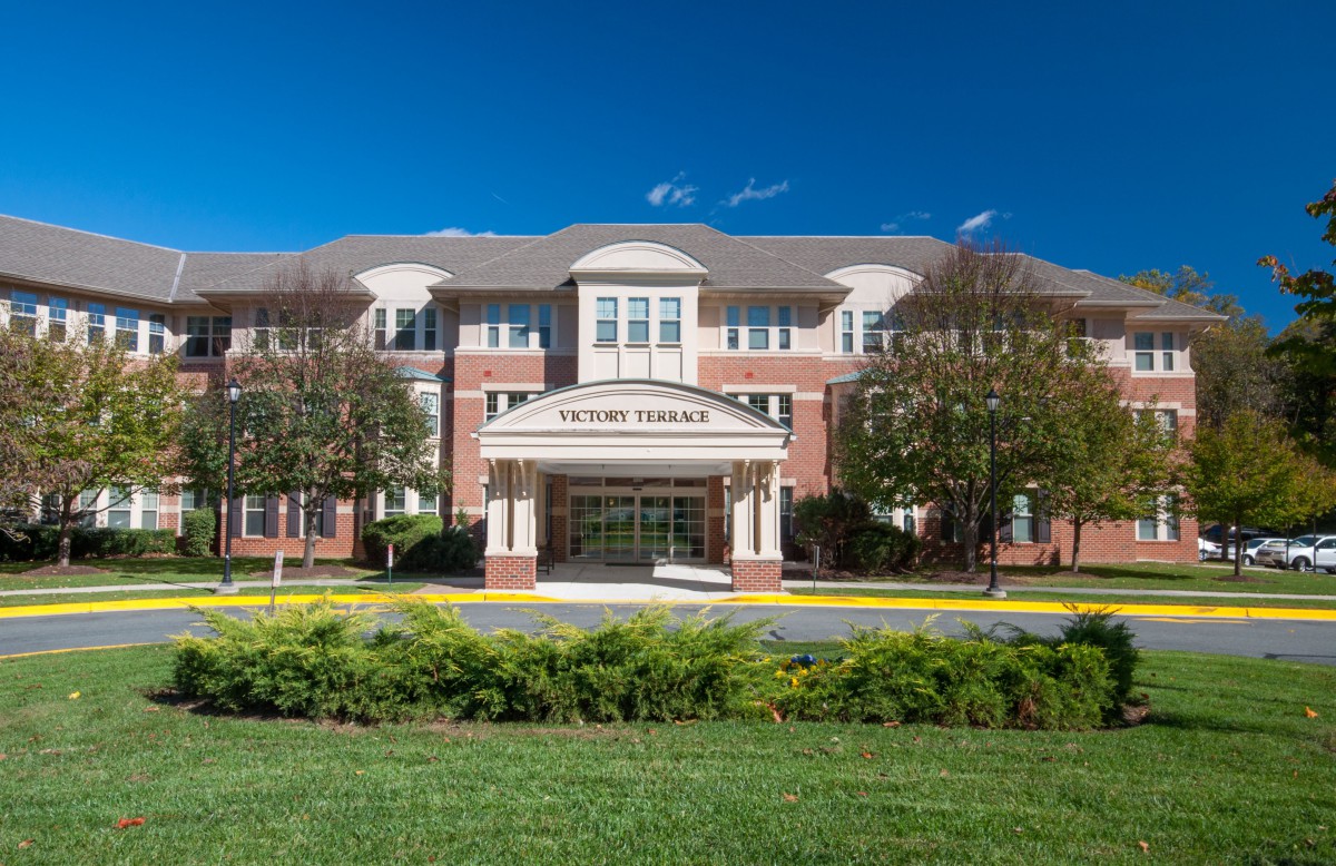 A library building with a grand entrance and landscaped surroundings.