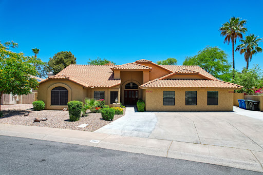 A beautiful single-family home with a tiled roof and well-maintained landscaping.