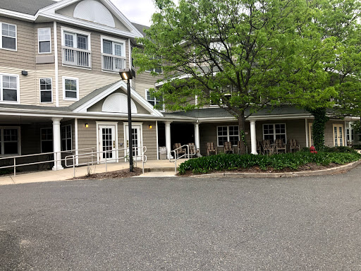 A charming residential building with a welcoming entrance and landscaped surroundings.