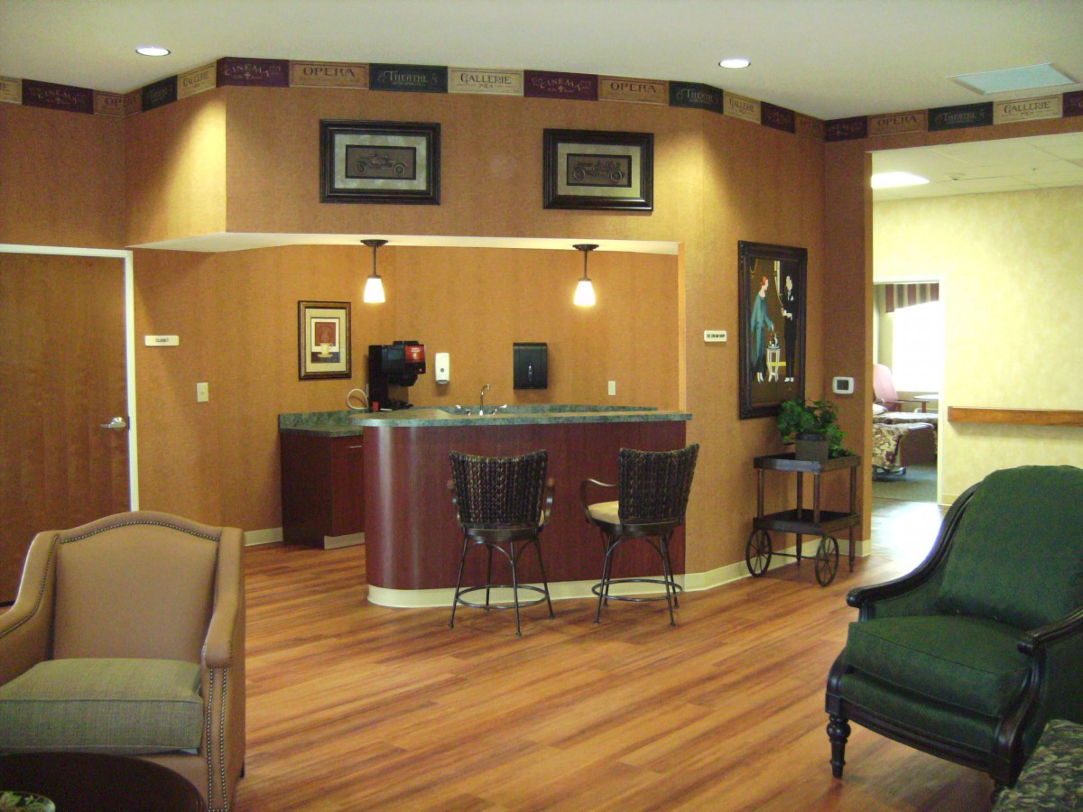 A cozy reception area with wood flooring and comfortable seating.