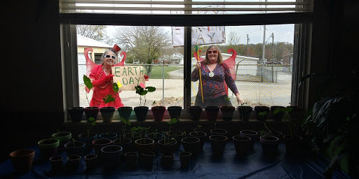 Celebrating Earth Day with creativity and gardening outside a community center.