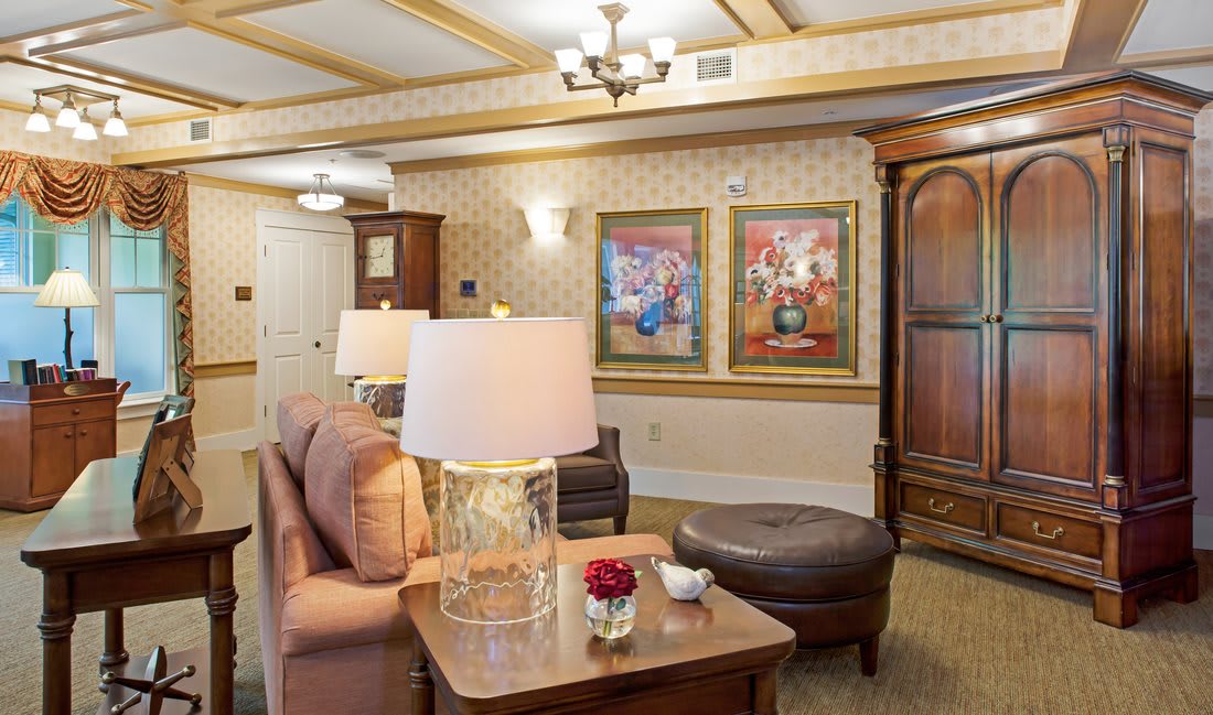 A cozy living room with comfortable seating, decorative artwork, and warm lighting.