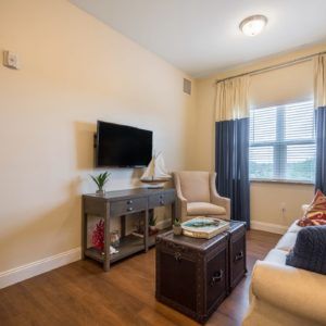 Cozy living room with a wall-mounted TV and comfortable seating.