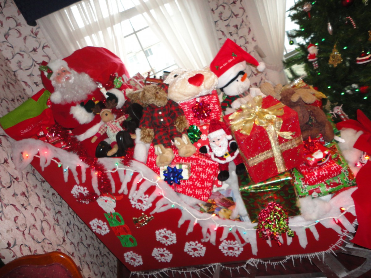 Festive Christmas decorations featuring Santa Claus, gifts, and ornaments in red and white.