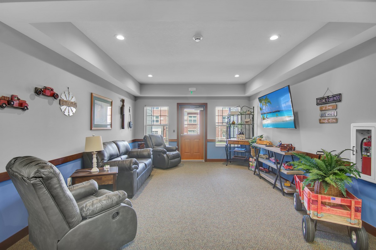 A cozy living room with comfortable seating, a large TV, and tasteful decor.