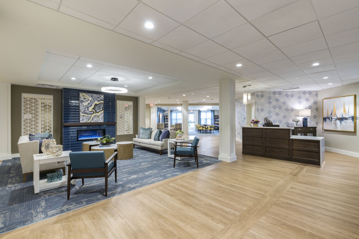 A modern lobby area with comfortable seating, a reception desk, and elegant lighting.