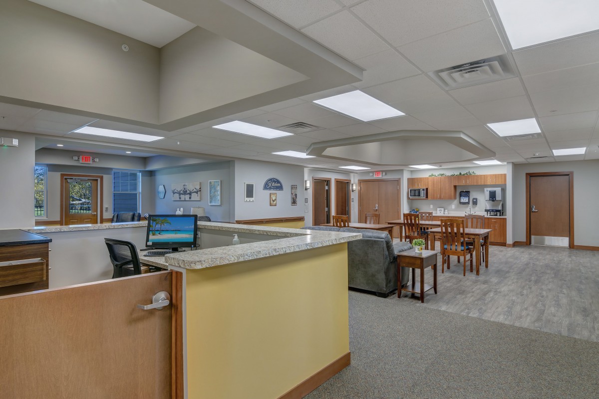 A spacious and modern reception area with a front desk, seating, and ample lighting.
